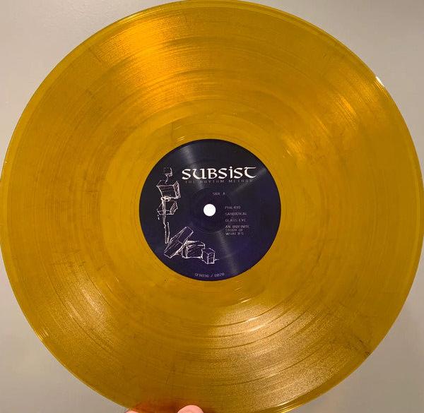 Subsist – The Rhythm Method - Gold with Black Smoke /100